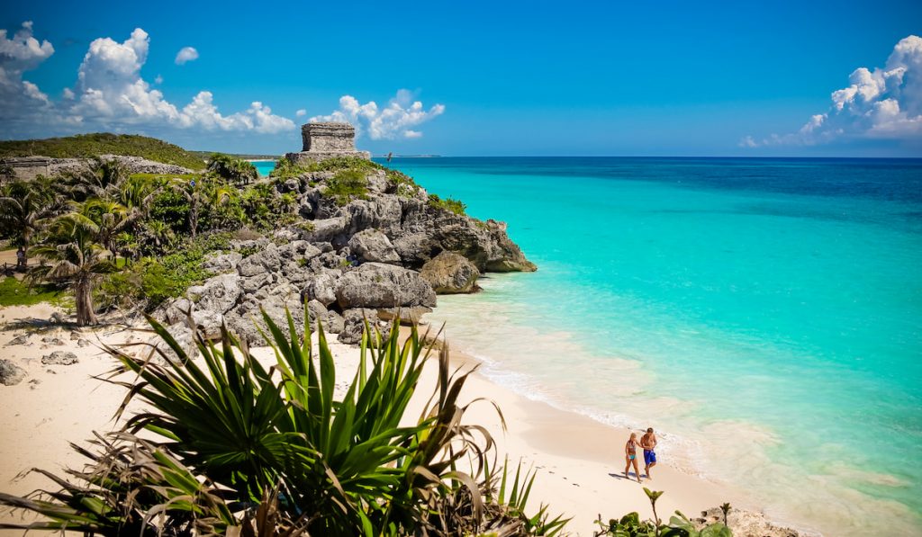 Couple walking on the beach Tulum, Mexico
